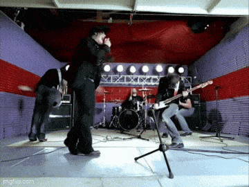a group of people playing instruments on a stage with the url imgflip.com in the lower right corner