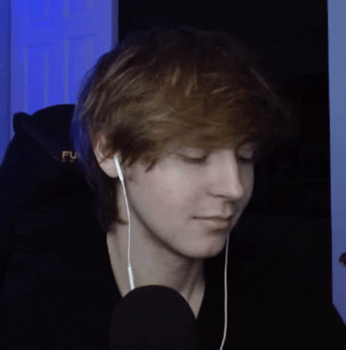 a close up of a person wearing headphones and a hoodie that says fu on it