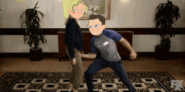 a man and a woman are dancing in a room with a fx logo on the rug