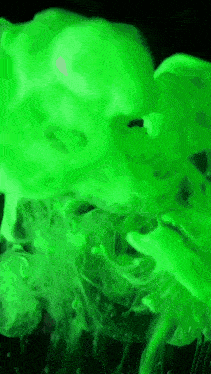 a green smoke coming out of a bottle on a black background .
