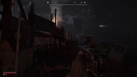 a person is holding a gun in a dark room with a fire coming out of a building .