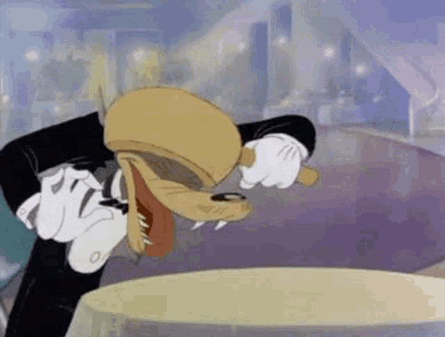 a cartoon character is sitting at a table with his head on his hand .