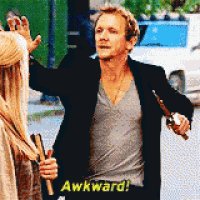a man in a black jacket is holding a sword and says " awkward "