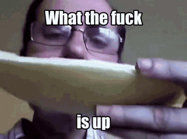 a man wearing glasses is holding a slice of pizza in front of his face and says what the fuck is up .