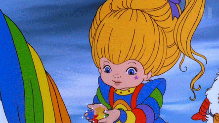 a little girl with a star on her face is holding a rainbow