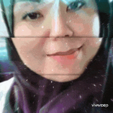 a woman wearing a purple scarf and a hijab is smiling in a vivavideo clip