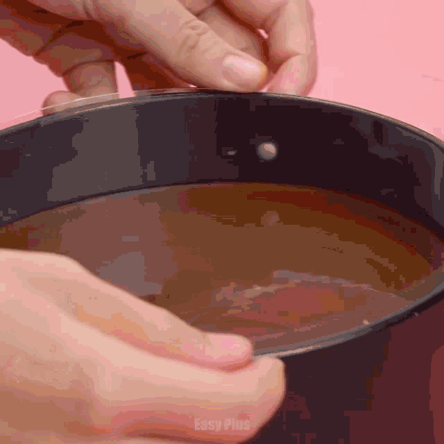 a close up of a person holding a bowl of liquid with easy plus written on the bottom of the image