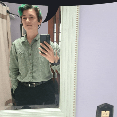 a person taking a selfie in front of a mirror