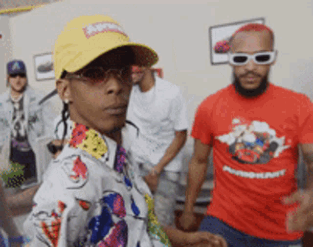 a man wearing a supreme hat is standing next to another man