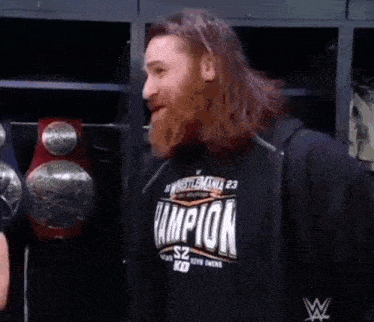 a man with a beard is wearing a champion sweatshirt
