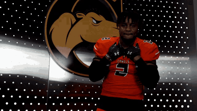 a man wearing an orange jersey with the number 9 on the front