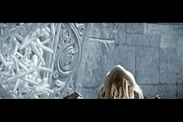 a close up of a person standing in front of a brick wall with ice on it .