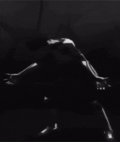 a black and white photo of a man kneeling down with his head down .