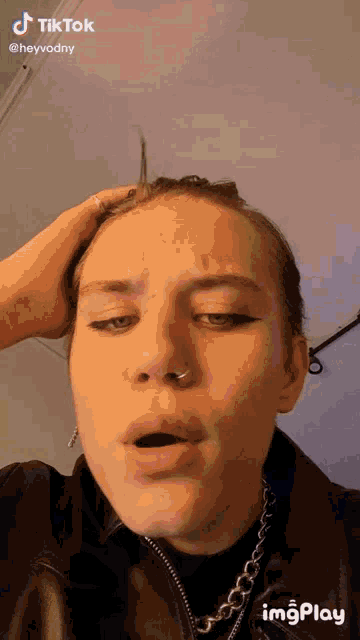 a woman with a nose ring is making a funny face