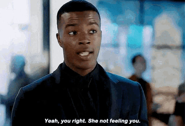 a man in a suit and tie is saying yeah you right she not feeling you .