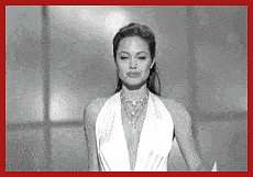 a black and white photo of a woman in a white dress with a red border