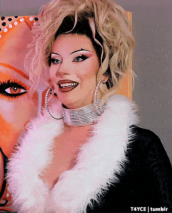 a woman wearing a fur coat and hoop earrings stands in front of a painting by tumblr