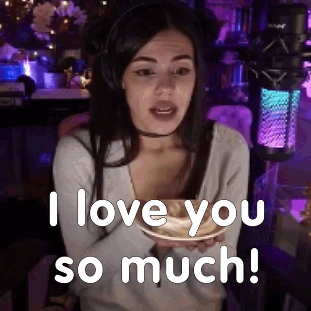 a woman holding a plate with the words i love you so much written on it