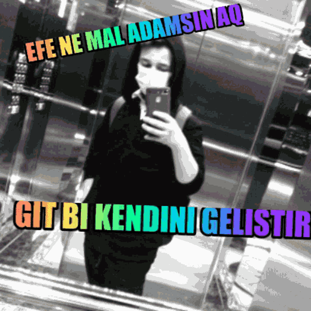a person taking a picture of themselves in an elevator with the words efe ne mal adamsinaq