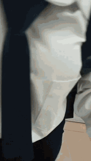 a person wearing a white shirt and black pants is standing