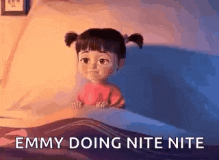 a cartoon girl is sitting in a bed with the words `` emmy doing nite nite '' written on it .