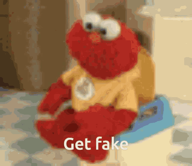 elmo is sitting on a potty with the words get fake written on the bottom