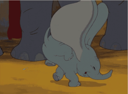 a baby elephant is crawling on the ground with its trunk outstretched