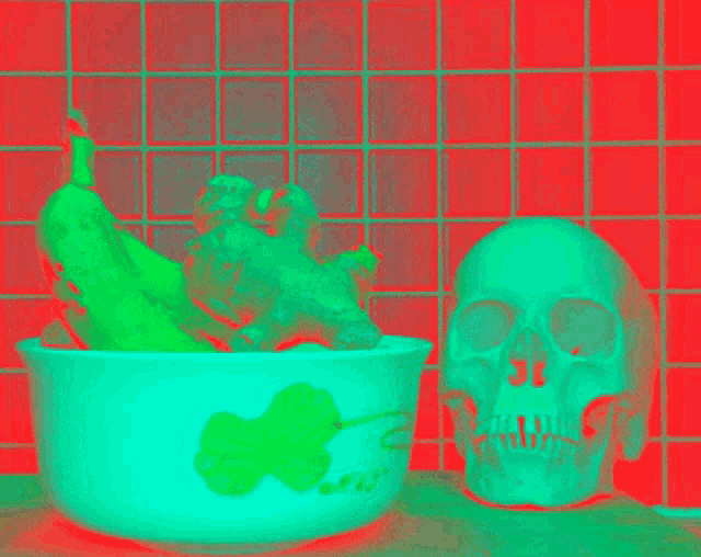 a skull sits next to a bowl of vegetables in front of a red tiled wall