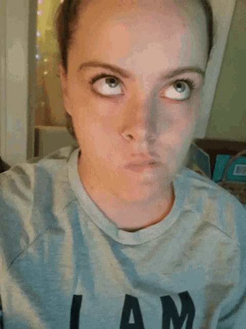 a woman wearing a shirt that says i am