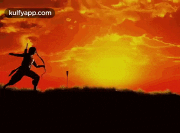 a silhouette of a man holding a bow and arrow against a sunset sky .