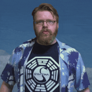 a man with a beard is wearing a shirt that says dharma on it