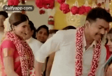 a man and woman are standing next to each other at a wedding .
