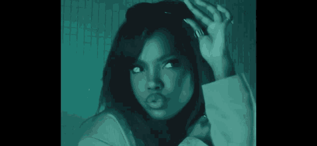 a woman with a ring on her finger is making a face