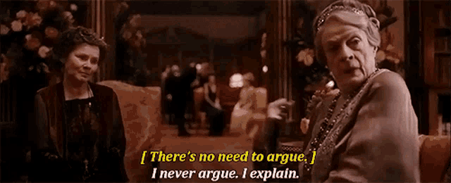 two women are sitting on a couch talking to each other and one of them is saying there 's no need to argue .