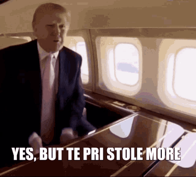 a man in a suit and tie is standing in an airplane with the words yes but te pri stole more below him