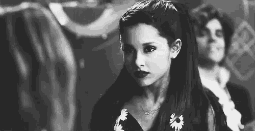 a black and white photo of ariana grande in a floral dress .
