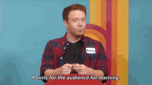 a man with a name tag that reads brennan points for the audience for learning