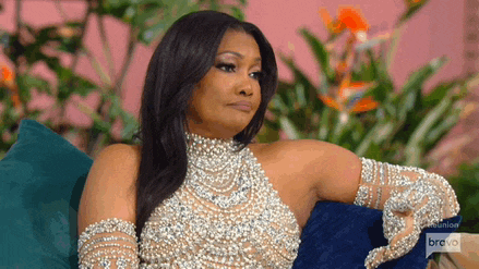 a woman in a pearl dress is sitting on a couch