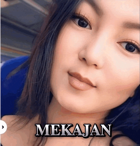 a close up of a woman 's face with the name mekajan written on it