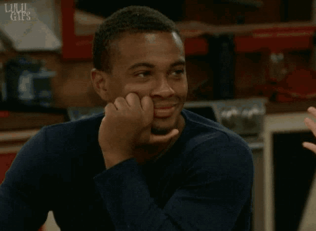 a man in a blue shirt is smiling with the word gifs on the bottom