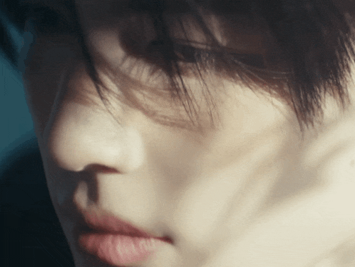 a close up of a person 's face with a shadow on it