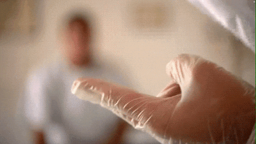 a close up of a person 's hand wearing a latex glove