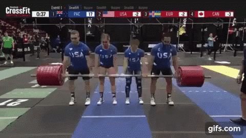 a group of people holding barbells in front of a screen that says crossfit on it