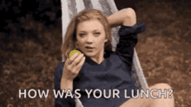 a woman is sitting in a chair eating an apple and asking how was your lunch