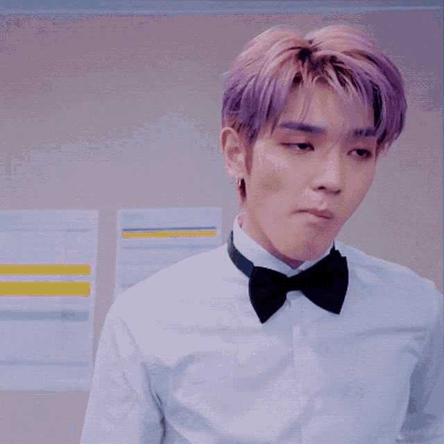 a man with purple hair wearing a bow tie