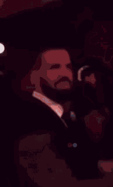 a blurry picture of a man sitting at a table with a laptop