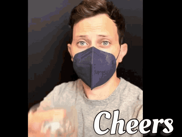 a man wearing a face mask with the word cheers written below him