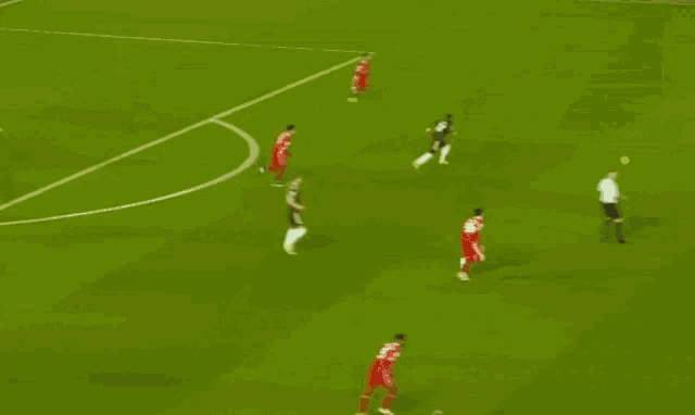 a group of soccer players are on a field and one has the number 6 on his jersey