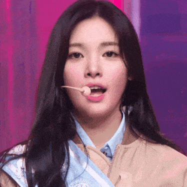 a close up of a woman 's mouth with a microphone sticking out of it