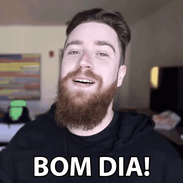 a man with a beard says bom dia in a black shirt
